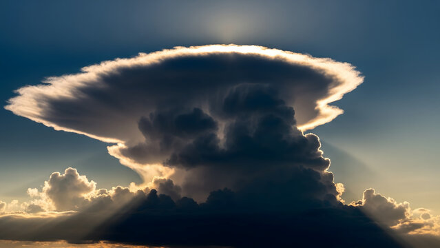 Dramatic Storm Cloud with Sunbeams and Heavy Rain at Sunset Epic Cumulonimbus Anvil Cloud over Horizon