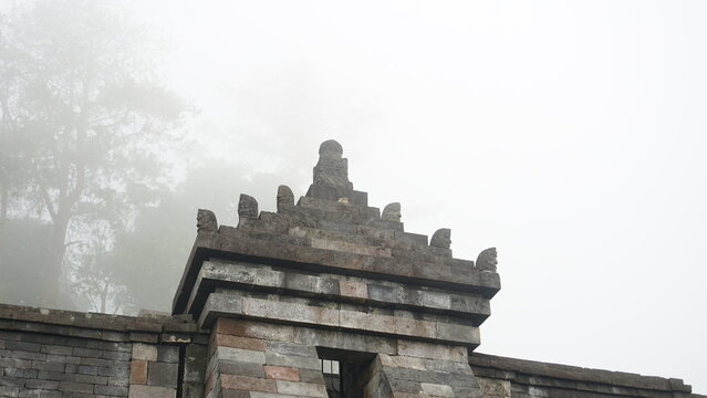 Ancient Stone Gate of Candi Cetho Shrouded in Morning Mist, Central Java, Indonesia