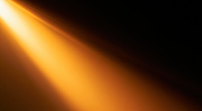 A diagonal beam of warm, golden light cuts across a dark background