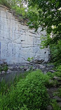Busky Canyon in summer, Cherkasy region, Ukraine. A cozy corner of wild nature in Ukraine with massive granite boulders and summer trees. Busky Granite Canyon, picturesque river Hirsky Tikich