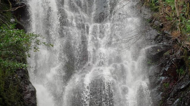 Majestic waterfall cascading down rocky cliff in Georgia, Caucasus.