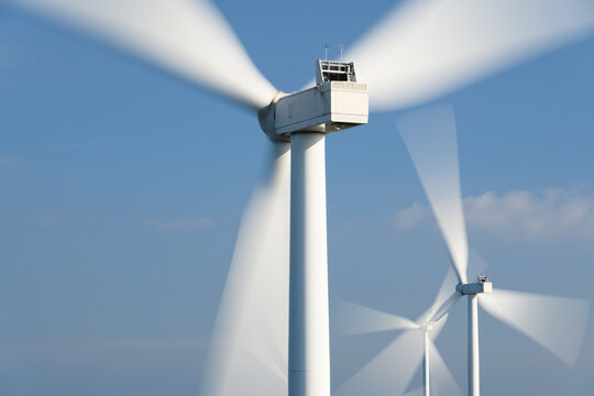 Close-Up of Spinning Wind Turbine Nacelle with Motion Blur Blades