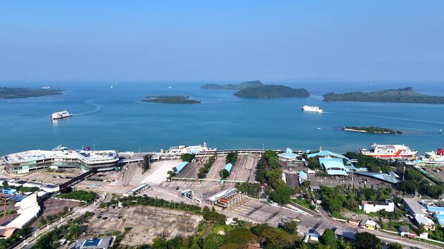 Bakauheni ferry port in Lampung, Sumatra, Indonesia during daytime. Ro-Ro ships docking and transporting vehicles across the Sunda Strait.