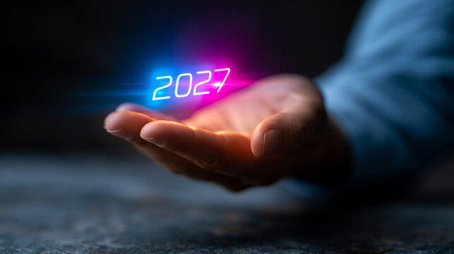 New Year 2027 holographic projection floating above a hand with a hologram.