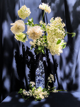 White flowers bouquet in blue vase