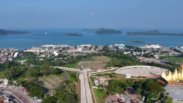Bakauheni ferry port in Lampung, Sumatra, Indonesia during daytime. Ro-Ro ships docking and transporting vehicles across the Sunda Strait.