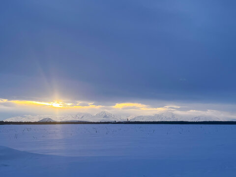 Sunset over snowy mountains in Alaska