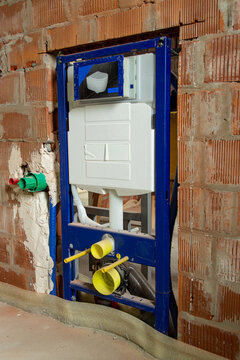 Concealed toilet installation frame inside unfinished brick wall background