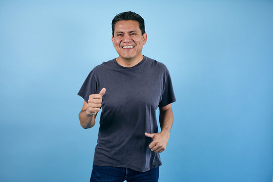 portrait of adult latin man in blue background in Mexico Latin America