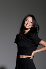 Fototapeta premium beautiful asian supermodel with toned abs smiling confidently, elegant asian fashion model with athletic physique and radiant smile, stunning asian beauty model showcasing fitness fashion and elegant 
