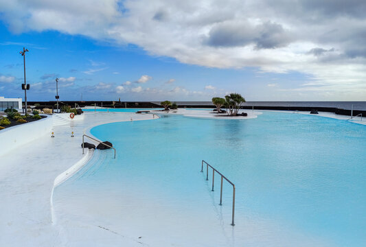 Arrecife, Lanzarote, Spain - December 17, 2025: Empty saltwater pool at Islote de Fermina, a landmark waterfront recreation complex created from Cesar Manrique's vision in Arrecife