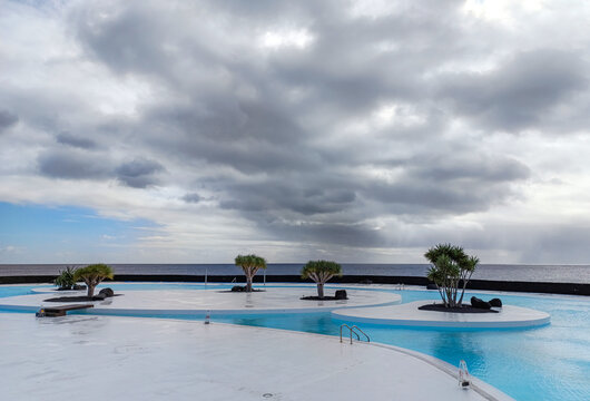 Arrecife, Lanzarote, Spain - December 17, 2025: Saltwater swimming pool at Islote de Fermina, a waterfront leisure complex designed by Cesar Manrique and restored as a public space