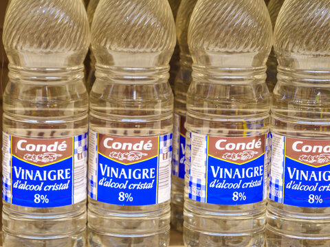 Conde brand Vinaigre d'alcool cristal. Bottles of crystal alcohol vinegar on supermarket shelf,