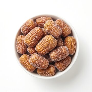 Top view of a white bowl filled with dried jujube fruits, also known as red dates, isolated on white background