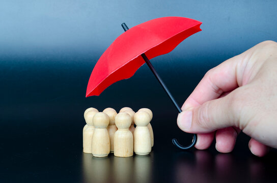 Wooden figures under red umbrella representing responsible leadership, trust, and future security