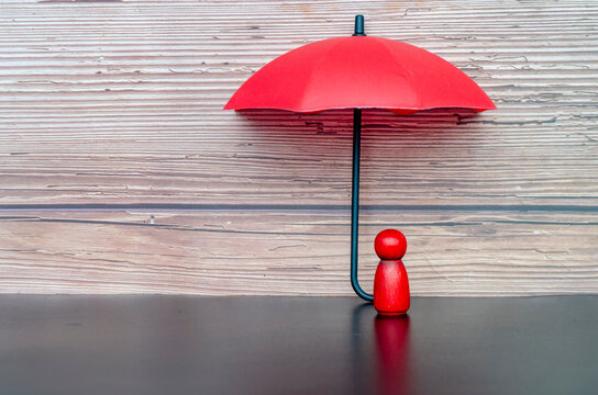 Minimal leadership concept showing umbrella protection over an individual leader with trust and safety assurance.