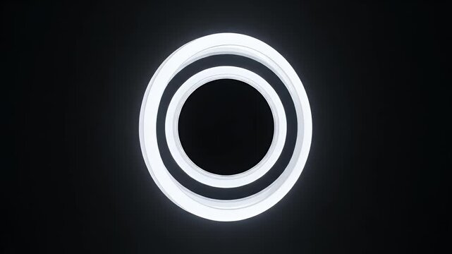 Abstract geometric luminous rings suspended in darkness.