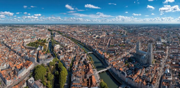 Wide angle aerial vista of dense urban sprawl with central river winding through ancient rooftops and historical city landmarks under bright summer daylight panorama cityscape architecture