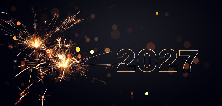two burning sparklers with glowing 2027 isolated on dark background, greeting card for happy new year party, december holiday season or anniversary celebration