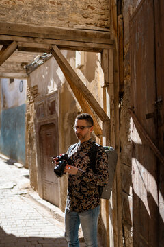 A man photographer in an alley
