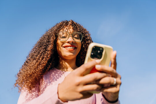A woman using a mobile phone standing outdoors