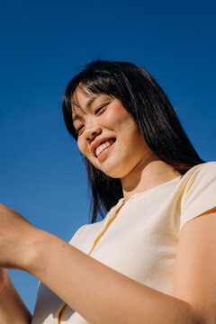 A woman using a mobile phone standing outdoors