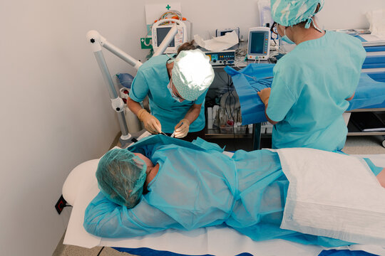 Dermatologists perform surgery on patient at a modern medical clinic