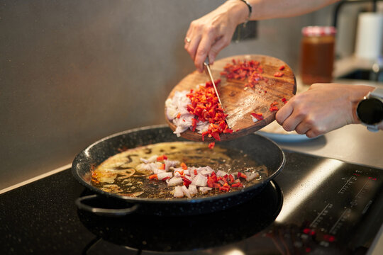 Chef Chopping Fresh Red Peppers and Onions