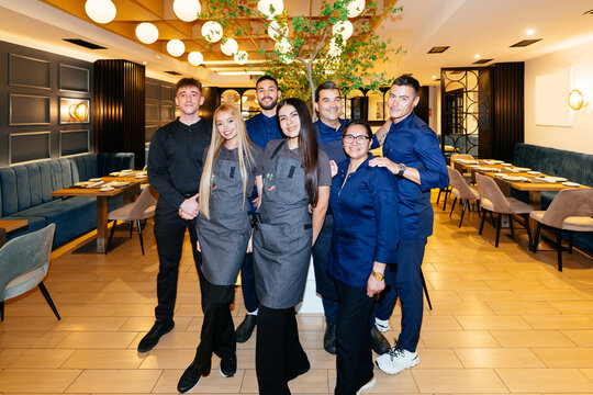 Restaurant staff team standing in modern dining room