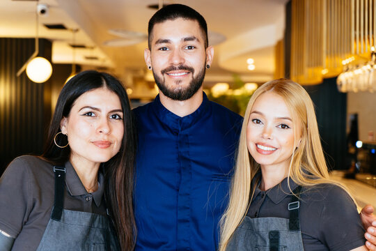 Diverse restaurant staff smiling, working as a team