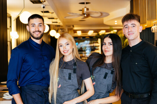 Restaurant staff smiling presenting hospitality team service