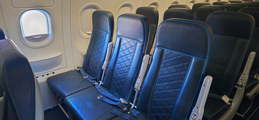 Fototapeta premium Empty Exit Row Seats in a Commercial Airplane Cabin