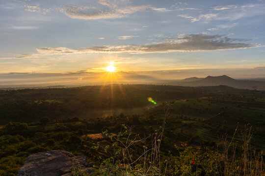 Sunrise Over Green Hills and Mountains in the Distance