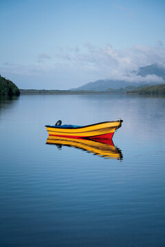 Yellow Boat on Still Water