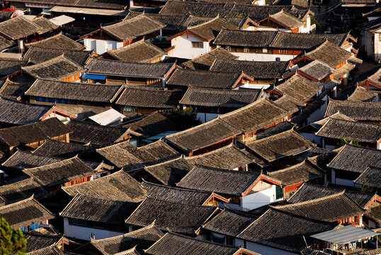 Traditional tiled rooftops of Lijiang Old Town at sunset