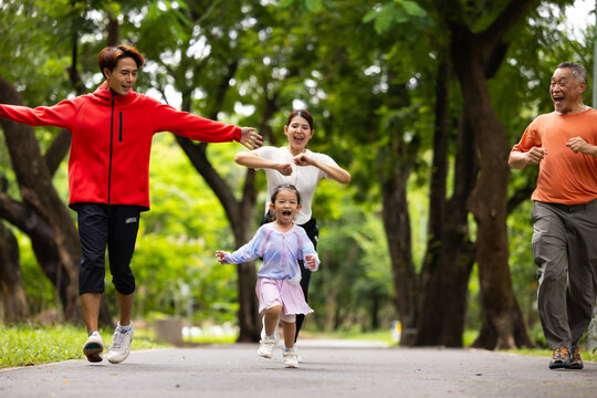 Family exercising and jogging together in city park summer. healthy lifestyle in nature. Father mother, kids daughter exercise. Family team, healthy children. healthy lifestyle and family bonding