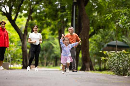 Family exercising and jogging together in city park summer. healthy lifestyle in nature. Father mother, kids daughter exercise. Family team, healthy children. healthy lifestyle and family bonding