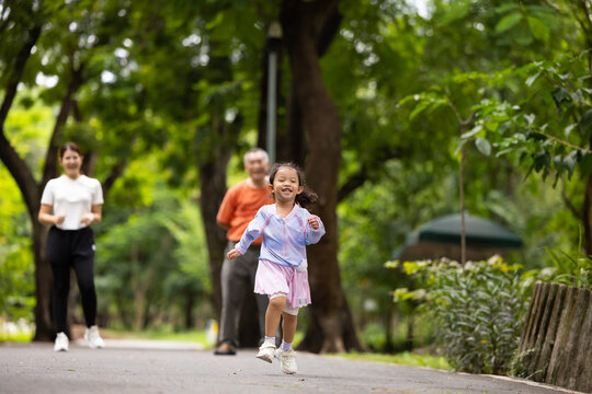Family exercising and jogging together in city park summer. healthy lifestyle in nature. Father mother, kids daughter exercise. Family team, healthy children. healthy lifestyle and family bonding