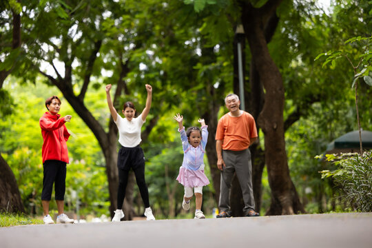 Family exercising and jogging together in city park summer. healthy lifestyle in nature. Father mother, kids daughter exercise. Family team, healthy children. healthy lifestyle and family bonding