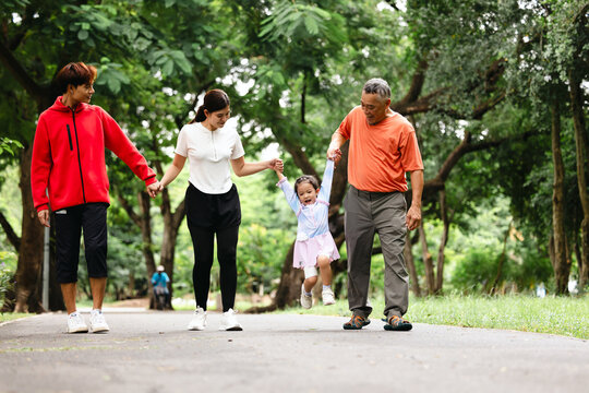 Family exercising and walking together in city park summer. healthy lifestyle in nature. Father mother, kids daughter exercise. Family team, children. healthy lifestyle and family bonding