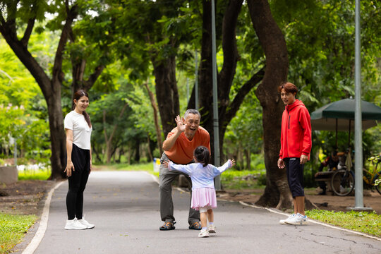 Family exercising and walking together in city park summer. healthy lifestyle in nature. Father mother, kids daughter exercise. Family team, children. healthy lifestyle and family bonding