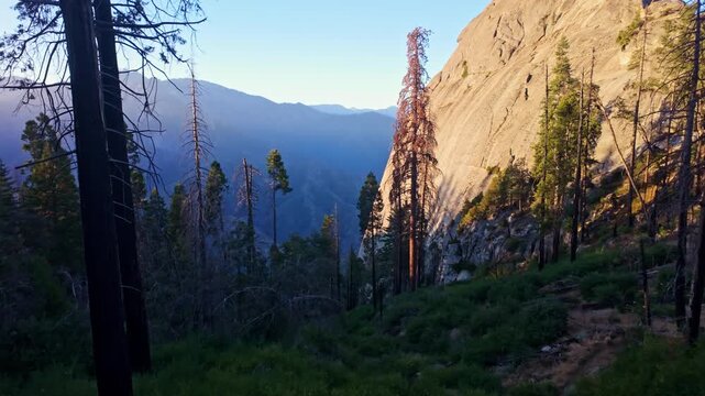 Golden sunrise light illuminates the granite dome of Moro Rock in Sequoia National Park