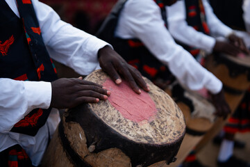 Close-up of musicians playing traditional hand drums during a cultural performance. Ideal for music, festivals, traditions and cultural heritage themes © Swastik