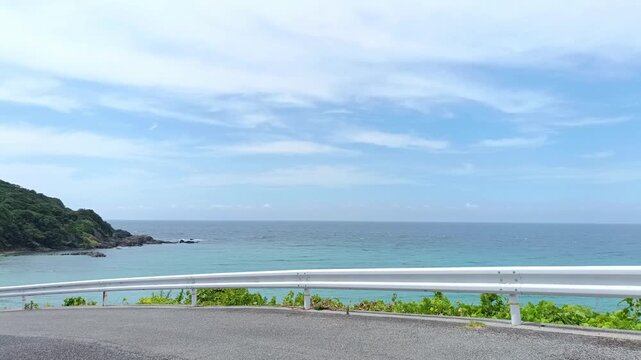 Blue Sea and Sky Seen from a Coastal Road