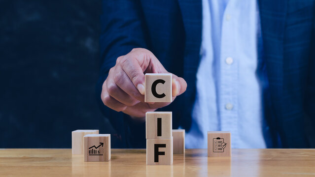 CIF Cost Insurance Freight incoterms concept. businessman touching letter on wooden cube for global trade shipping and logistics business. not ai