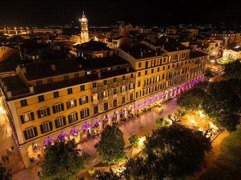 Aerial close-up view of the Liston arcades and cafes with purple lanterns and diners during the Resurrection night celebrations in Corfu island, Greece