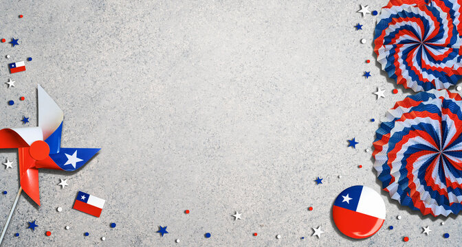 Chilean flag pinwheel and rosettes with confetti on a gray background