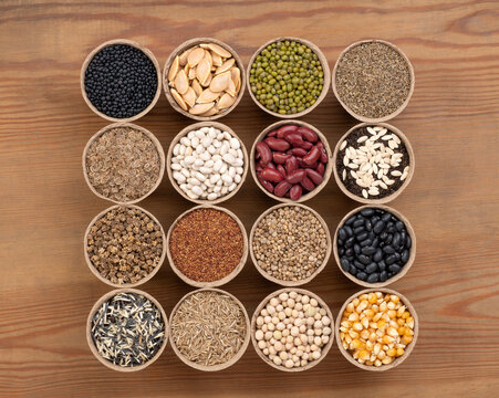 Seeds in peat pots on a wooden table or worktop, top view 