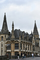 Pedestrians Crossing Bridge by Neo Gothic Post Palace in Ghent © Constanza