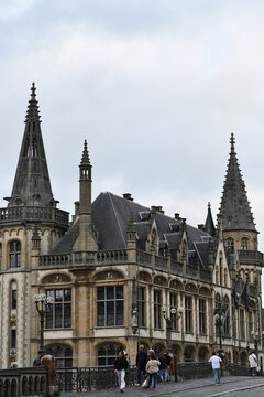 Pedestrians Crossing Bridge by Neo Gothic Post Palace in Ghent